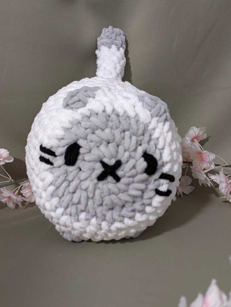 White crochet loaf cat plushie with a grey face patch and X nose