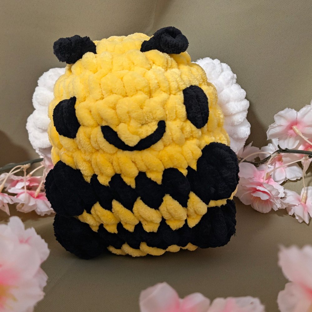 Yellow and black crochet sitting bee plushie with white wings